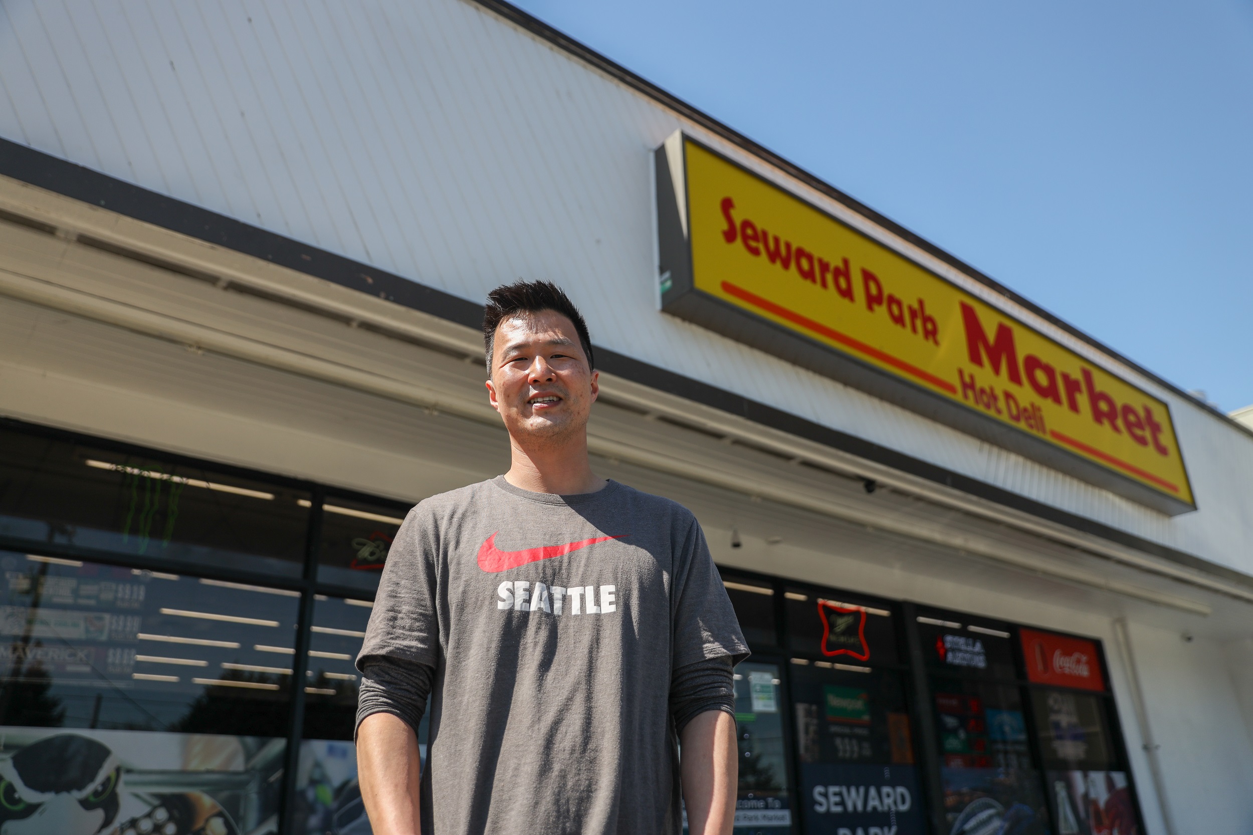 Richard wearing a Seattle t-shirt standing in front of Seward Park Market