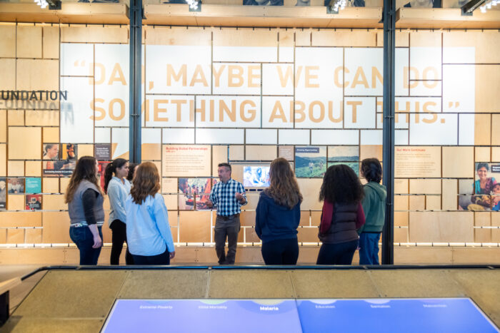 Visitors on a gallery tour with staff at the Bill & Melinda Gates Foundation Discovery Center.