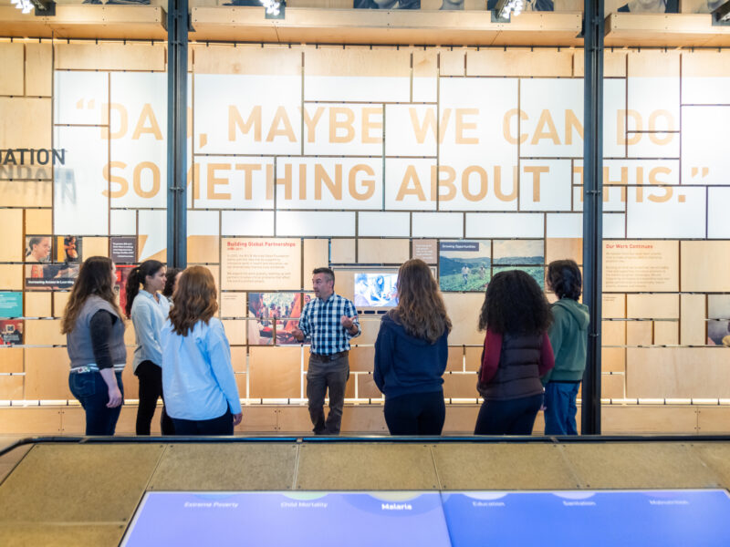 Visitors on a gallery tour with staff at the Bill & Melinda Gates Foundation Discovery Center.