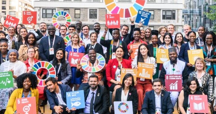 large group pictured in New York City all holding signs for the UN's Global Goals.