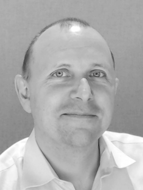 Black and white headshot image of Discovery Center staff member Andy Gordon-Maclean.