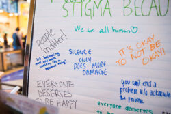 Close up of sign with hand-written messages of stigma affirmations