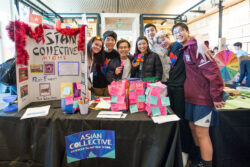 Mercer Island High School Asian Collective club members smiling together at Teen Action Fair.