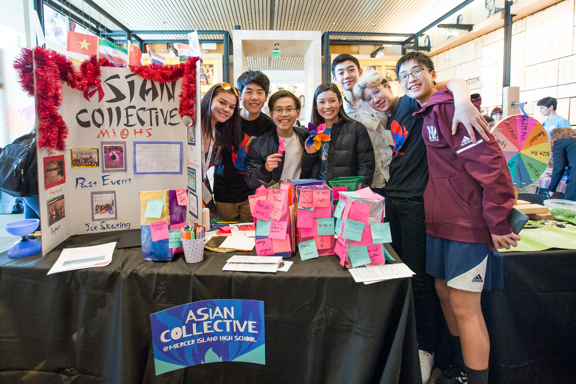 Mercer Island High School Asian Collective club members smiling together at Teen Action Fair.