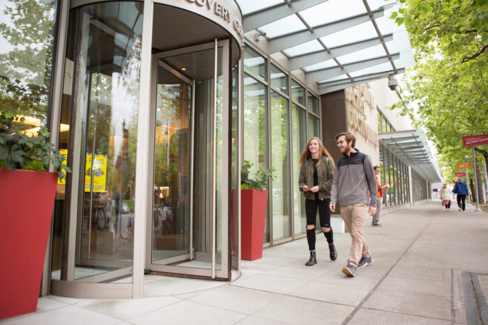 Two visitors enter the Discovery Center, exterior.