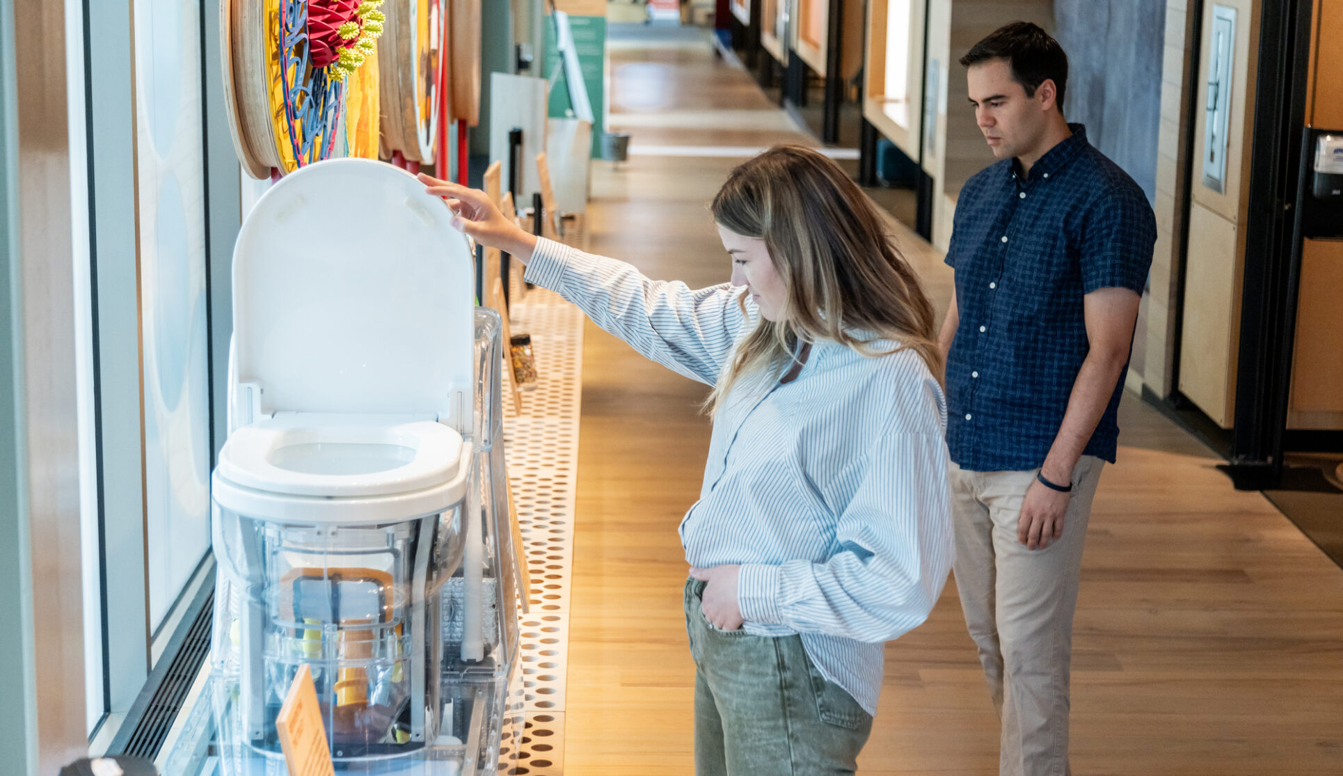 A visitor examines the reinvented toilet on the ramp of the Discovery Center.