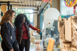 Two young adult visitors examine a reinvented toilet on display at the Bill & Melinda Gates Foundation Discovery Center.