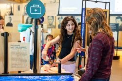 Visitors interact with Welcome gallery installations.