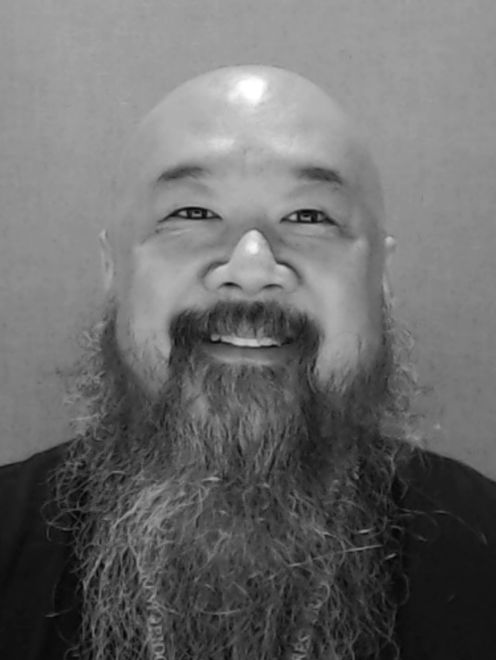 Black and white headshot image of Discovery Center staff member Shaun Koyama.