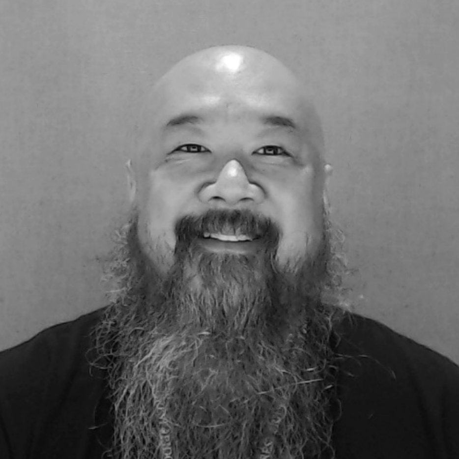 Black and white headshot image of Discovery Center staff member Shaun Koyama.