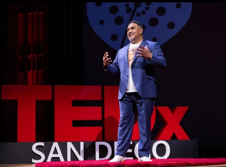 Speaker Jesse Leon on stage speaking at a TEDx event.