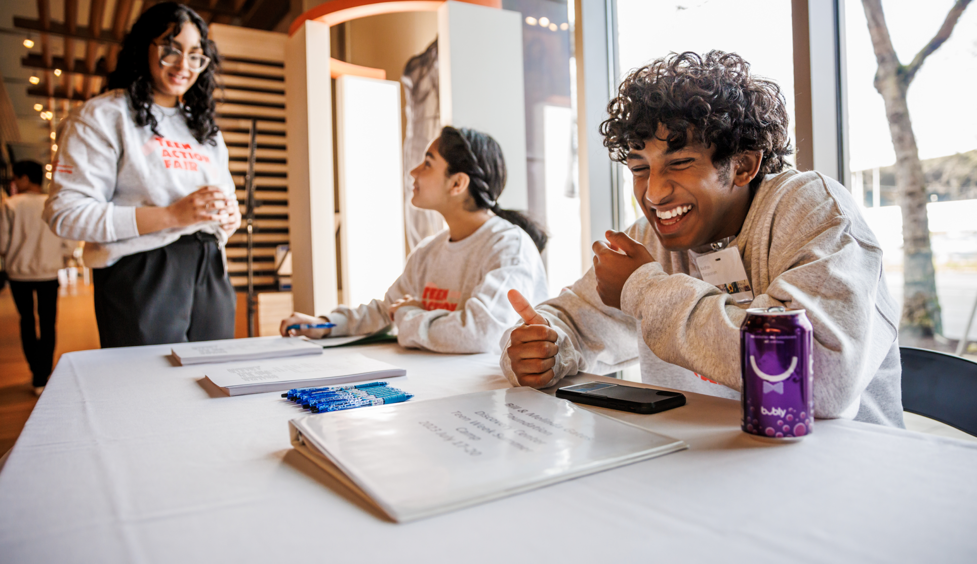 Youth Ambassadors laughing together during Teen Action Fair 2023.