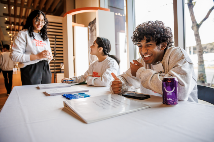 Youth Ambassadors laughing together during Teen Action Fair 2023.