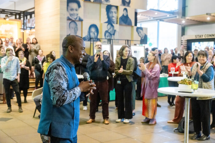 Doulaye Kone speaks to a crowd of guests at the Discovery Center.