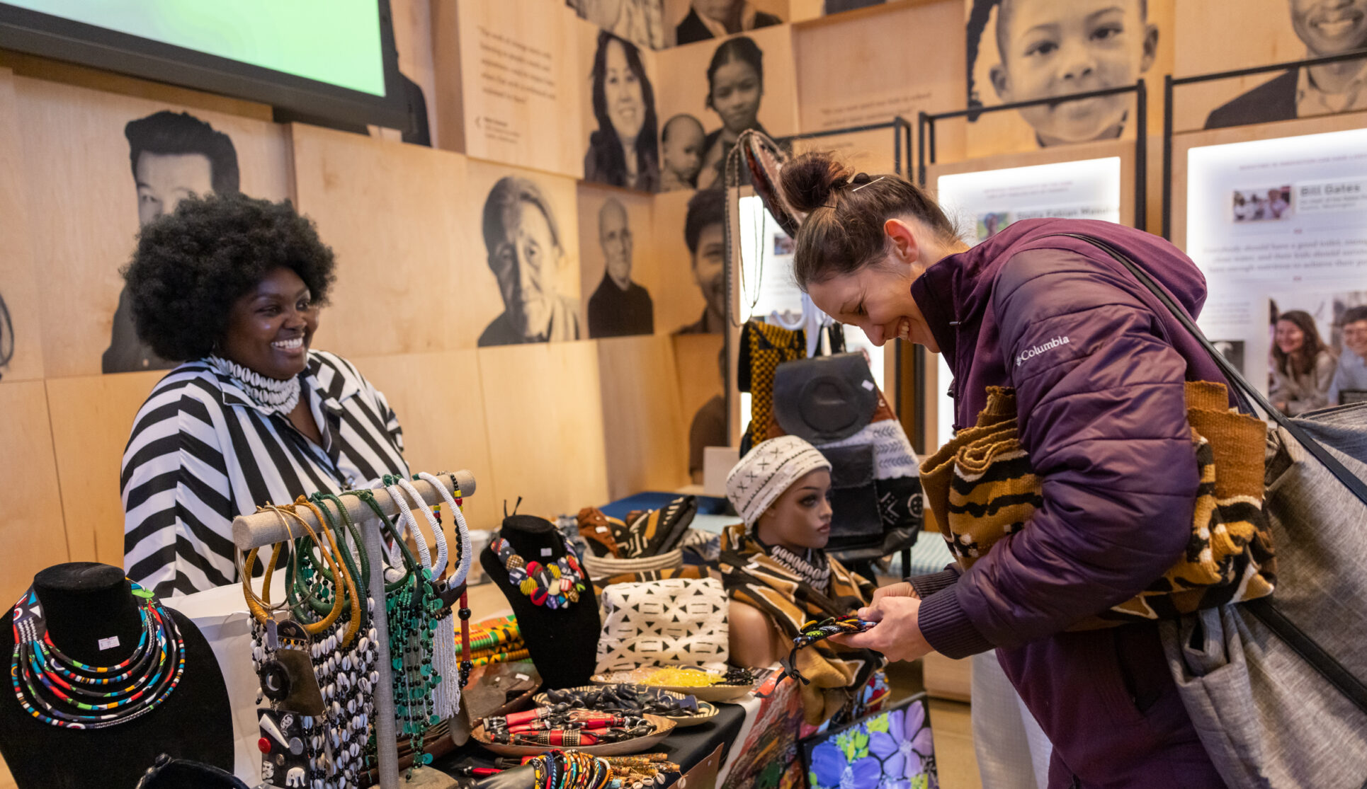 Vendor smiling at visitor as they present their products