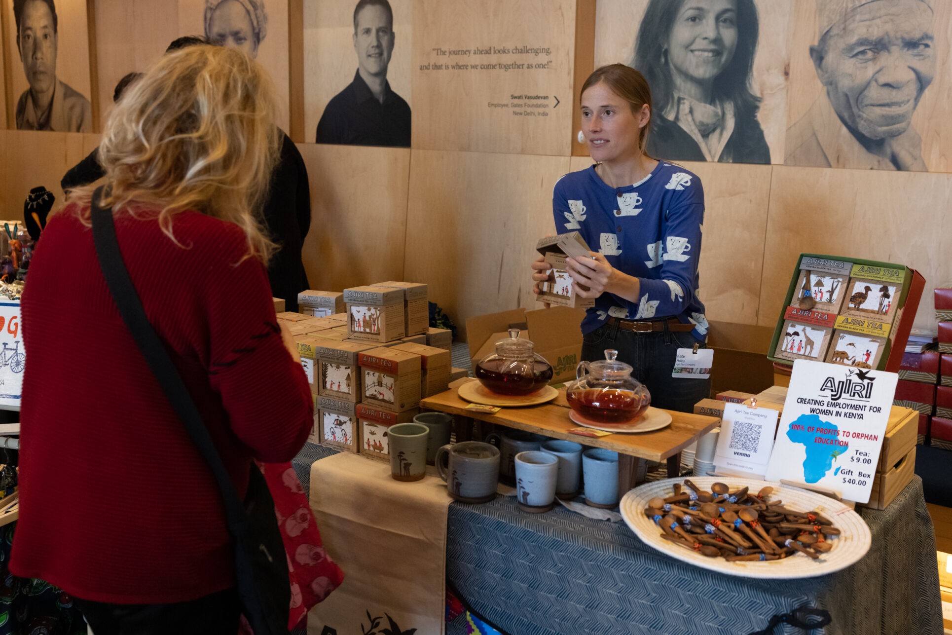 Vendor smiling at visitor as they present their products
