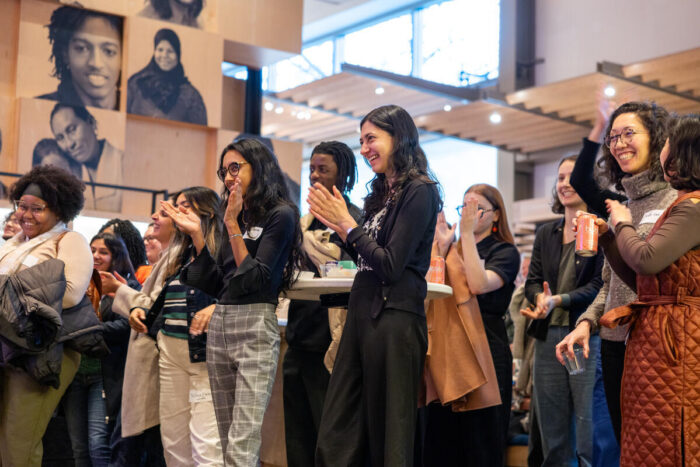 Guests applaud during and event at the Gates Foundation Discovery Center.