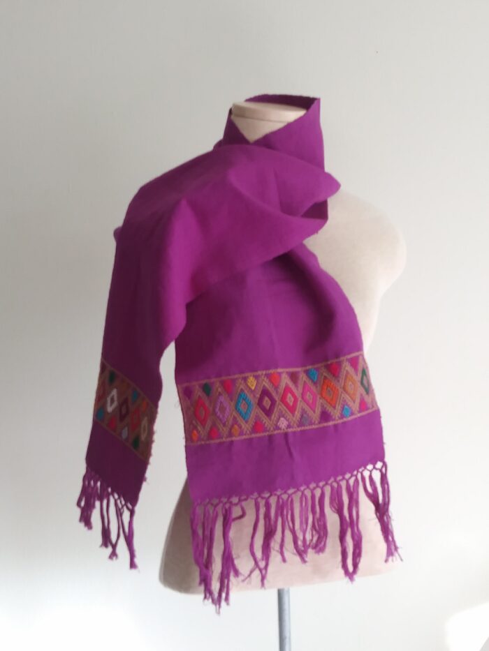 a purple scarf wrapped around a mannequin torso on a white background