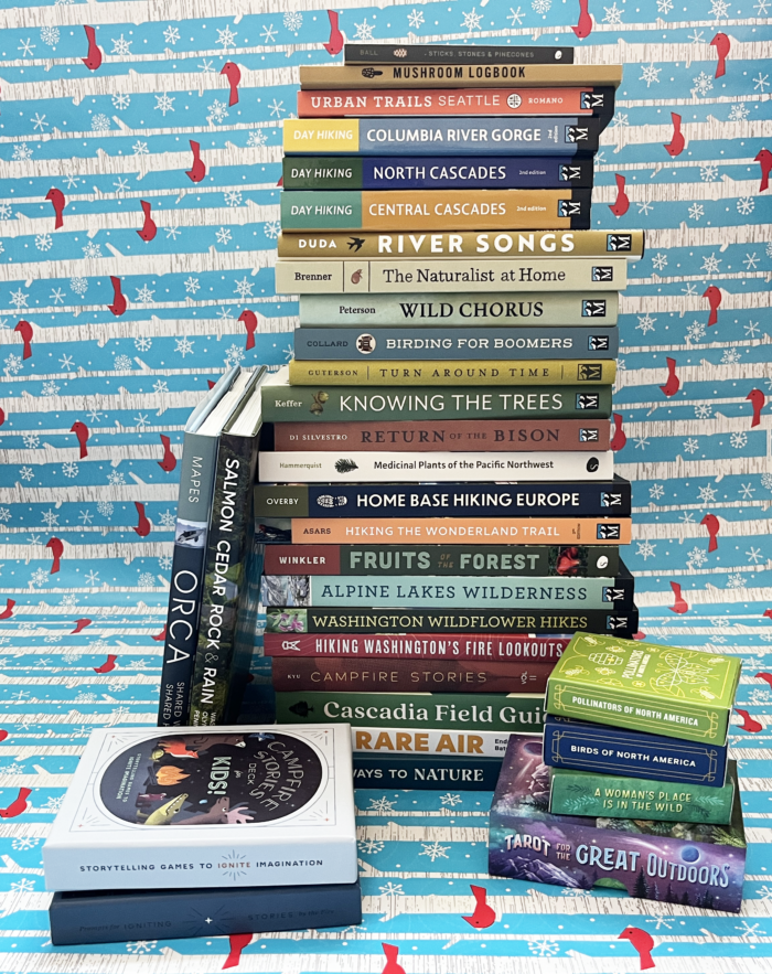 Stack of books with spines toward the camera and a blue and white background.
