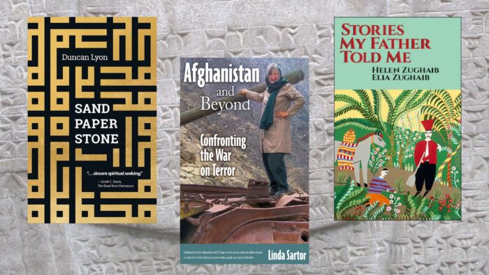 Various books on a grey stone background