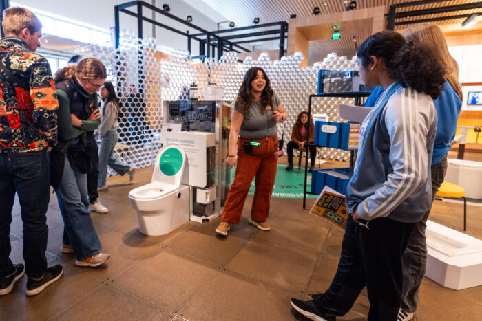 Visitors listen to staff on a sanitation tour at the Discovery Center